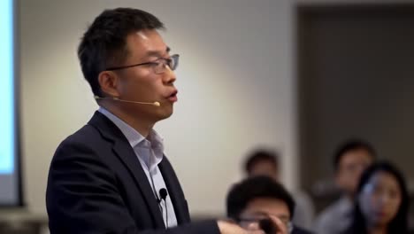 engaging presentation: a speaker shares insights on innovation and technology with an enthusiastic audience during a professional event