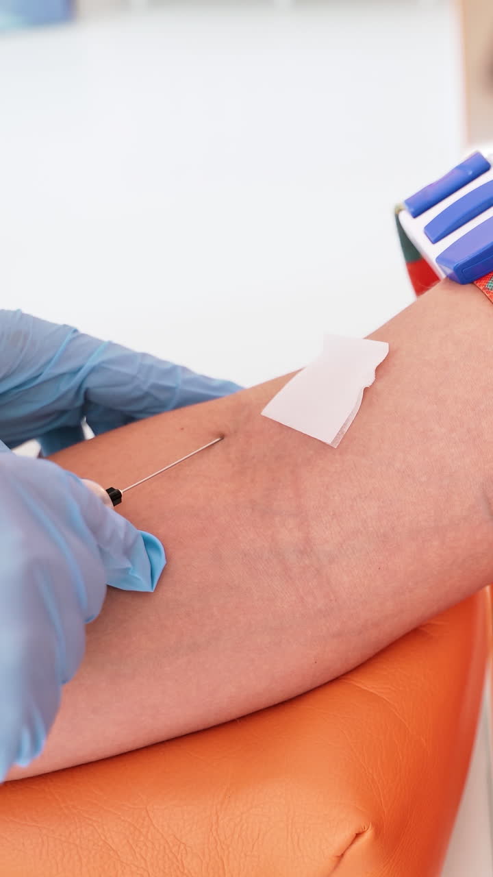 Patient waiting for blood collection. In modern clinic doctor preparing the patient to take blood taste. Vertical video