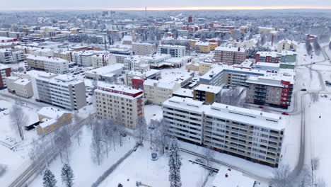 aerial view rotating away from downtown kajaani city, winter day in finland