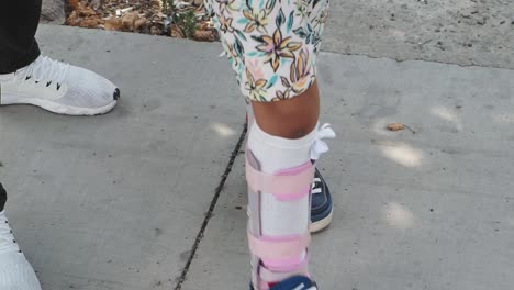 child wearing leg braces and sneakers