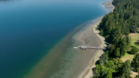 aerial view of a private dock extending from freeland, washington's shore out into the pacific ocean