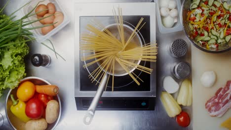 cooking spaghetti and vegetables