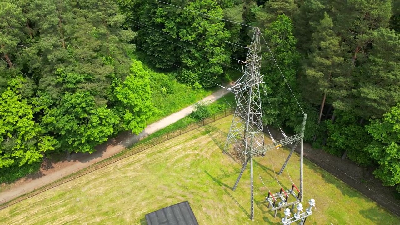 Aerial View of High Voltage Transmission Tower in Summer Forest