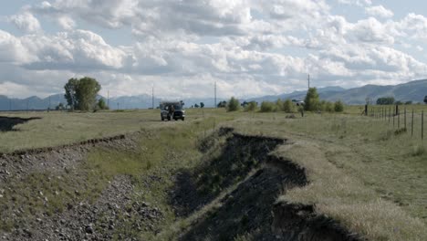 Truck-with-camper-parking-along-a-country-road