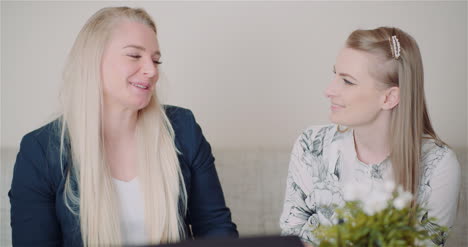 two happy sisters hugging together and giving support to each other smiling into camera 1