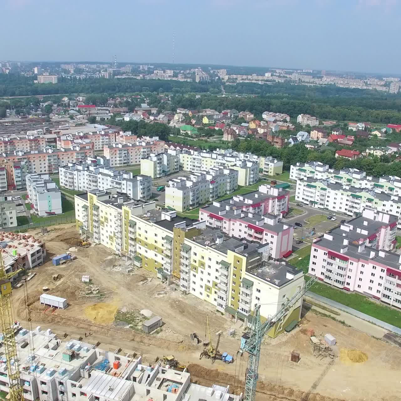 building materials and equipment are located on the site of the construction of modern high-rises. Aerial view