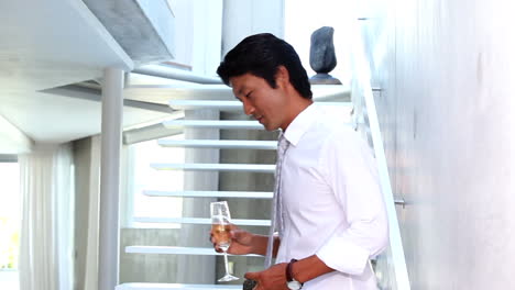 Man-walking-down-stairs-and-looking-at-engagement-ring