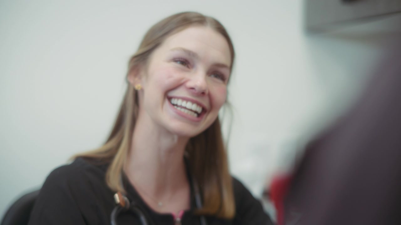 Vet smiling while talking to the owner