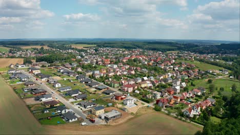 aerial drone shot of small czech village with houses and cars during summer