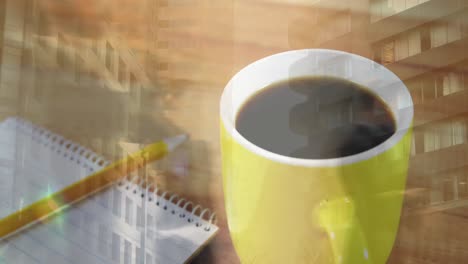 Animation-of-cityscape-over-notes-and-cup-of-coffee