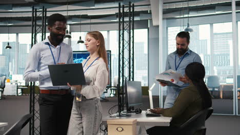 female engineer and coworker coding ai algorithms to debug software issues