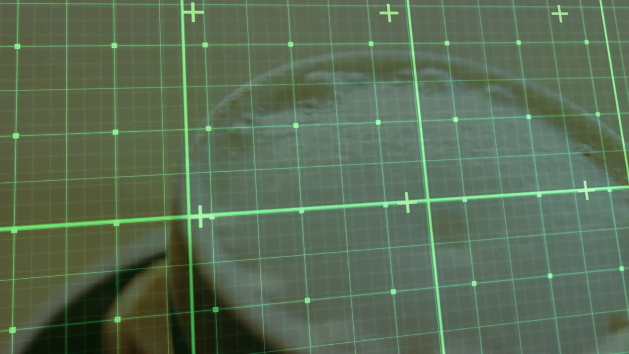 Circular beige disc rotating under green grid, highlighting scanning interface with crosshair nodes