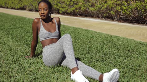 sporty woman relaxing on lawn