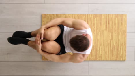 man doing yoga pose on mat