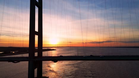 Aerial-spectacle:-Humber-Bridge-bathed-in-sunset-glow,-cars-in-transit