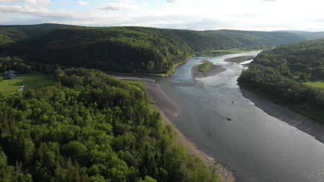 fly over drone footage of fly fishing at retsigouche river, new brunswick, canada