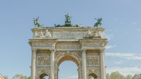 famous arch of peace with statues on top against blue sky