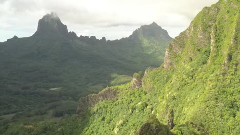 aerial parallax shot revealing a stunning mountain range in mo'orea island, french polynesia