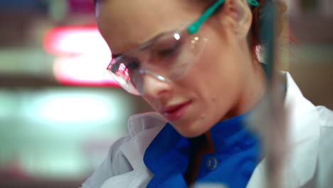 female scientist mixing chemical liquid in lab flask. scientist cure research