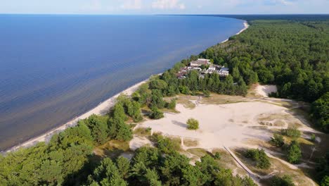 aerial drone footage of plienciems white dune in latvia on a sunny summer day. scenic baltic sea bay views, peaceful nature, and coastal landscape captured in cinematic quality
