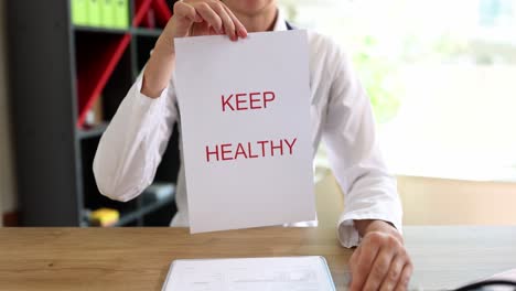 doctor holding 'keep healthy' sign