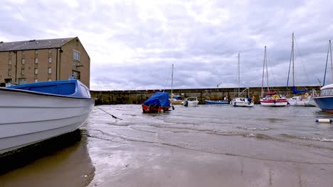 boats anchored near a sandy beach in fife