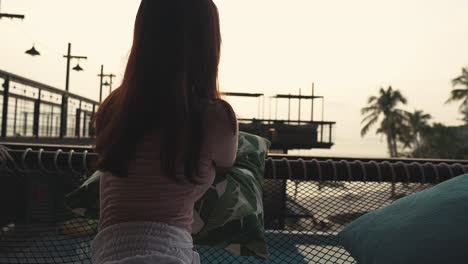 Girl-lie-down-in-hammock-and-enjoying-sunset