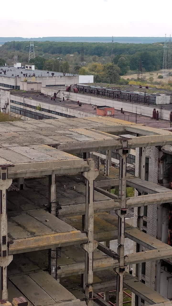 Drone view of old ruined factory. Damaged industry city buildings. Vertical video