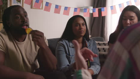 Friends-At-Home-Celebrating-With-Party-For-American-Independence-Day-4th-July-Talking-And-Drinking-3