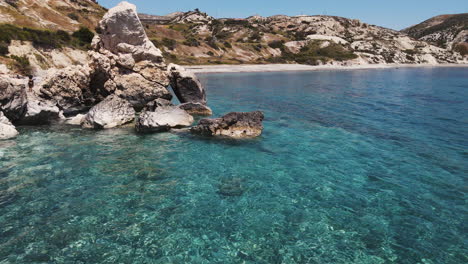 flyover idyllic turquoise mediterranean sea in petra tou romiou, cyprus