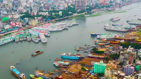 Buriganga-River-Port-With-Boats-And-Passenger-Ferries-In-Dhaka,-Bangladesh---Aerial-Drone-Shot