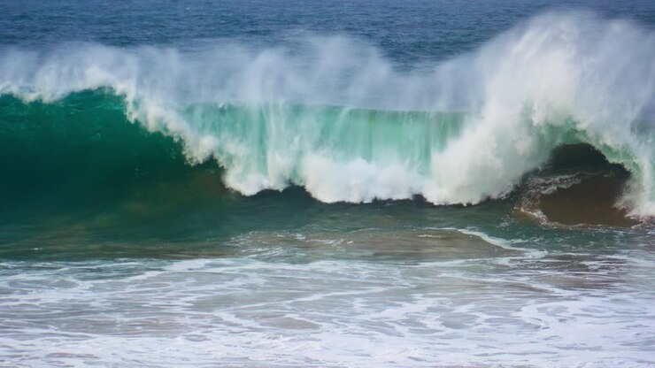 Huge ocean surf barrelling in super slow motion. Powerful wave rolling breaking