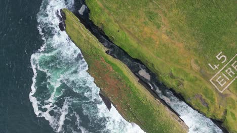 loop head peninsula with waves and text marking, aerial view of ww ii memory