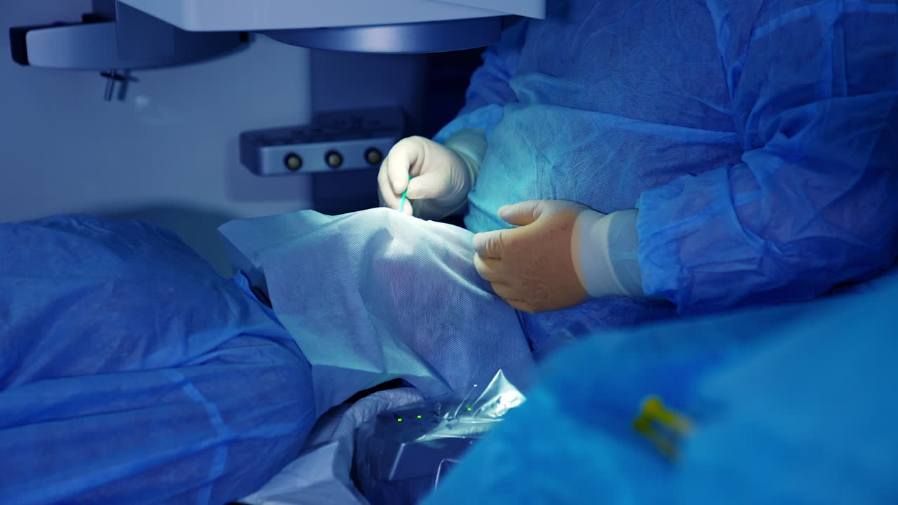 Surgery at medical ophthalmology clinic. Doctor at ophthalmology surgery during laser vision correction