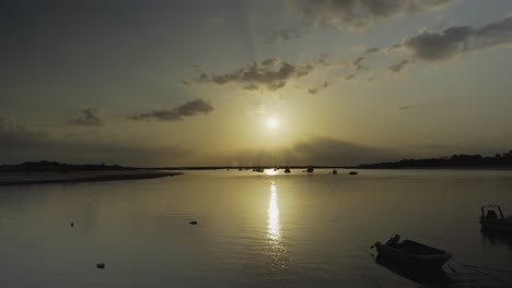 River-sunshine-in-the-morning-with-silhouette-boats-floating-Tavira-Portugal