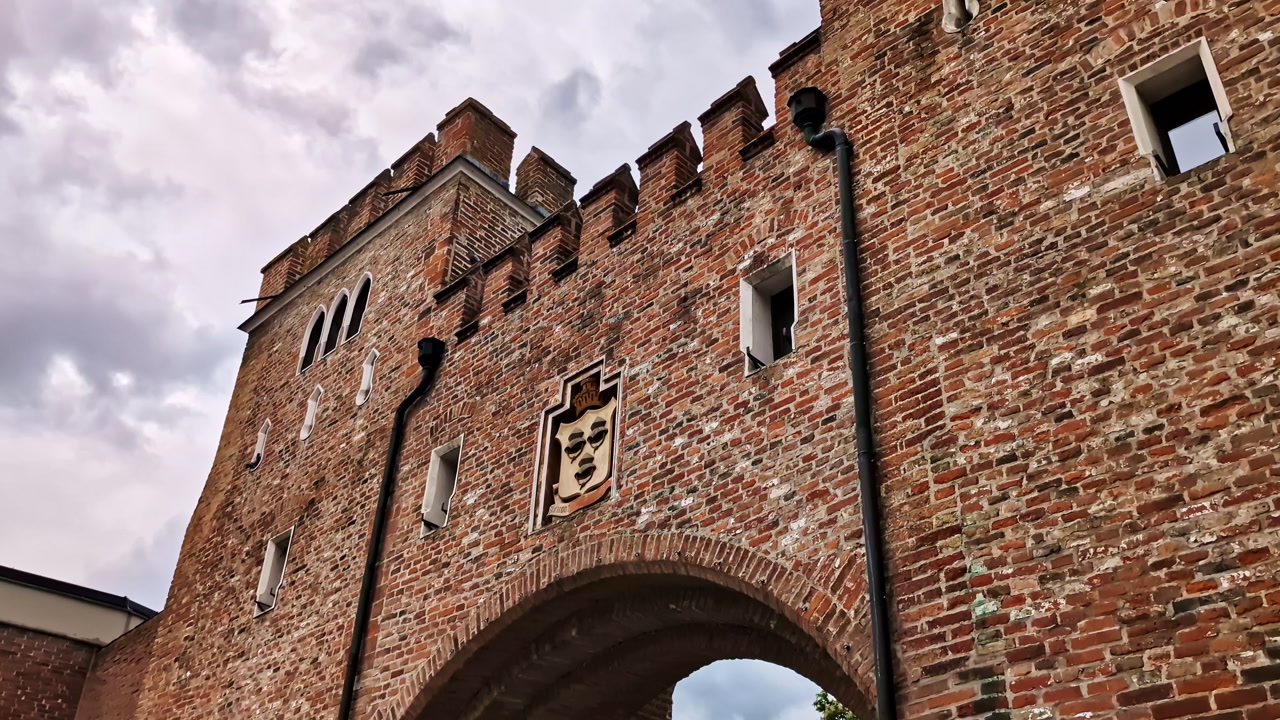 Historic Landtor brick gate and tower with cloudy sky in Landshut, Germany