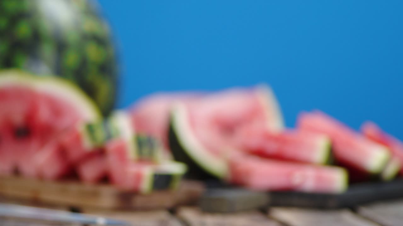 Sliced watermelon on a wood cutting Board.