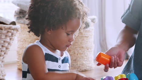 young black girl playing with her mum in sitting room