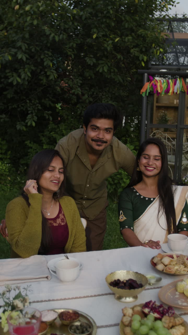 Friends Enjoying an Outdoor Meal in a Garden Setting