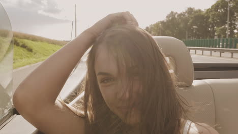 woman enjoying a road trip in a convertible