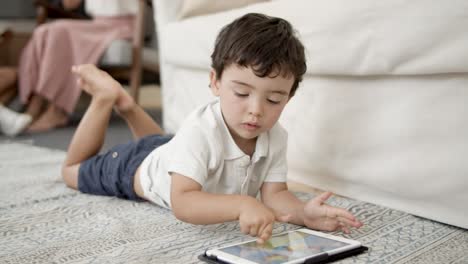 cute little boy lying on floor in living room