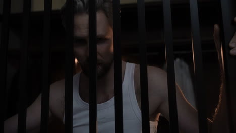 Closeup-of-man-behind-bars