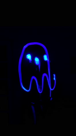 vibrant blue neon ghost light painting animation on black background. 4k vertical video