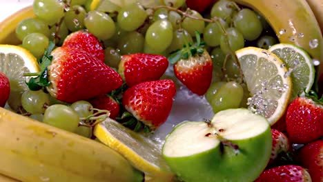 few strawberries falling into water