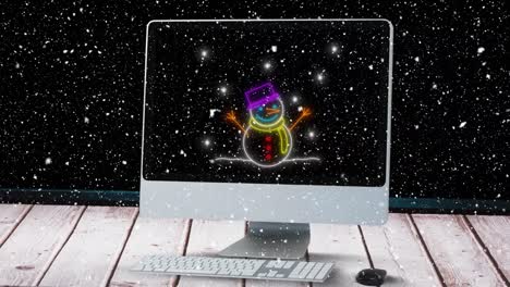 Animation of snowman on computer over snow falling at christmas