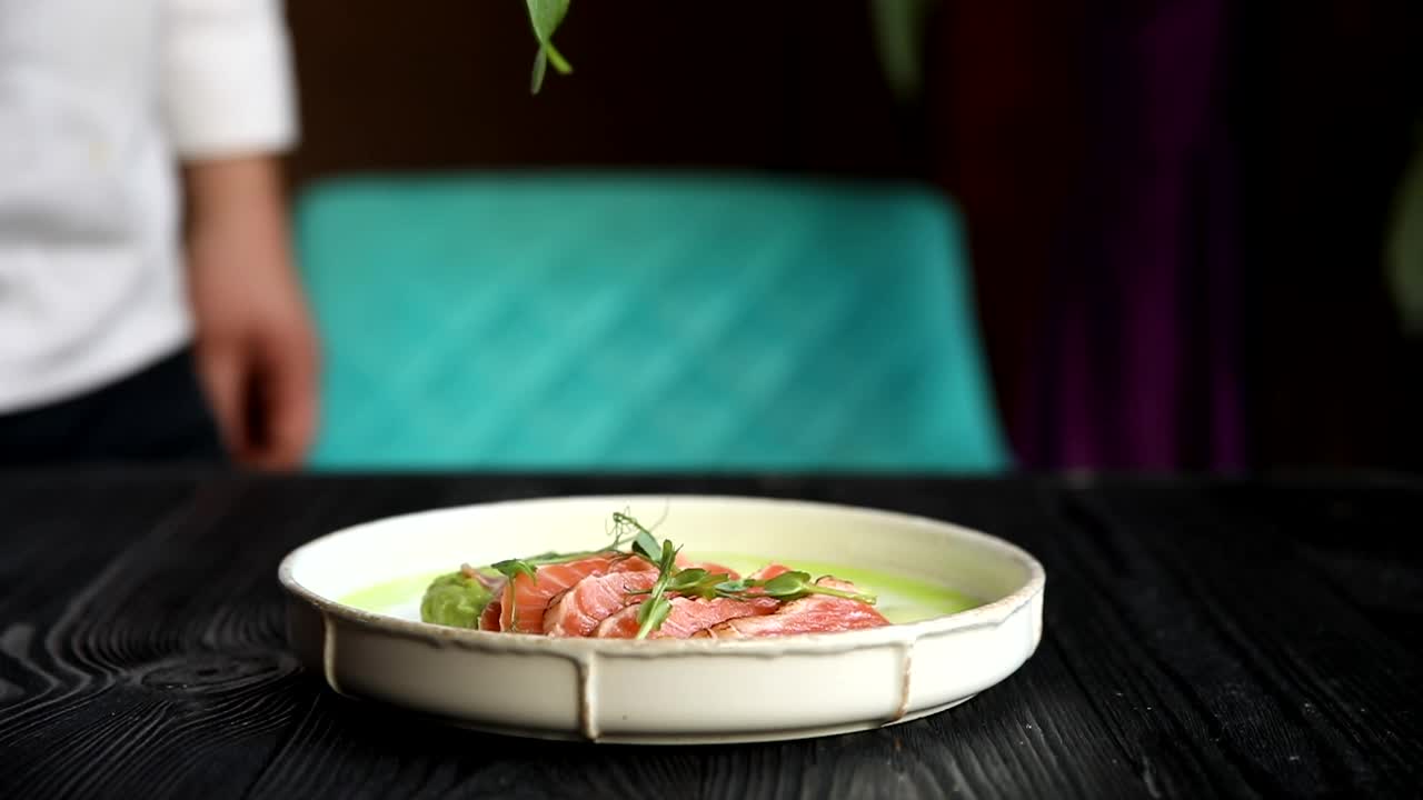 Chef Preparing a Salmon Dish with Spinach