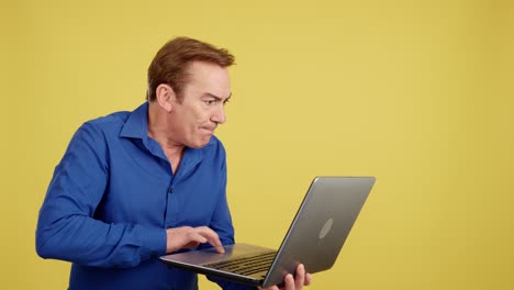 man using laptop with varied expressions on yellow background