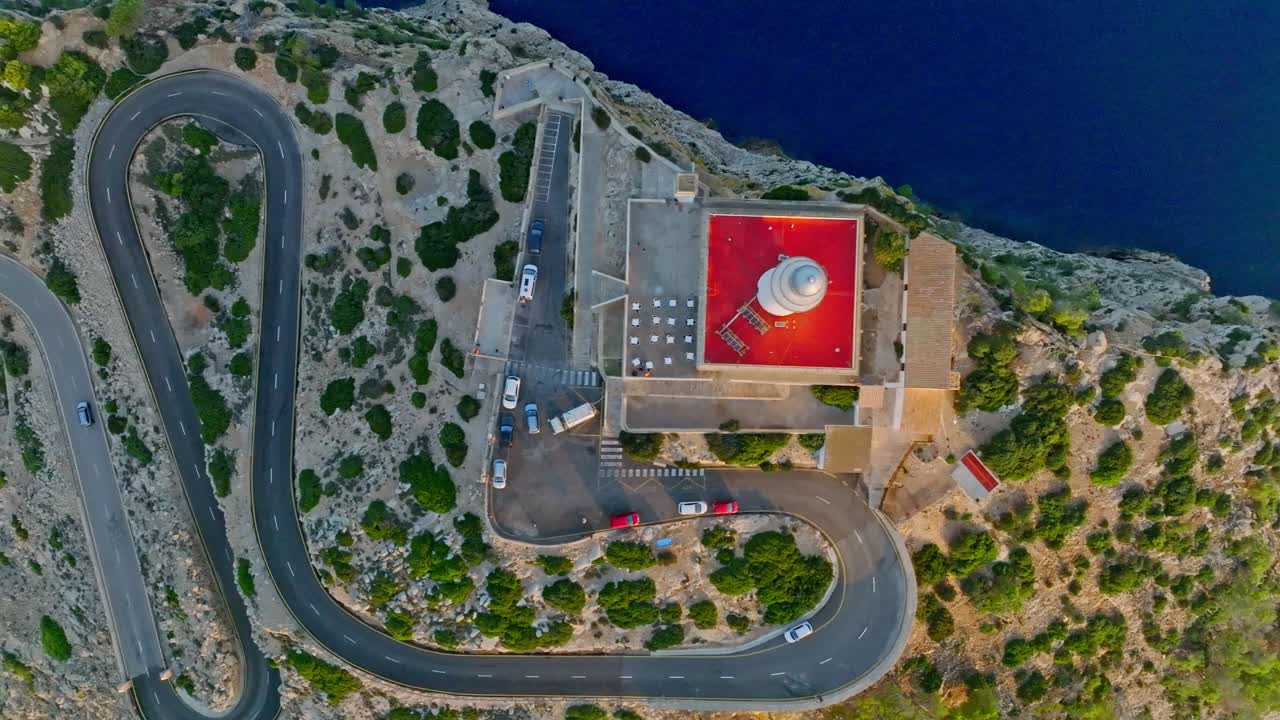 Bird's eye view of Formentor Lighthouse with a winding mountain road