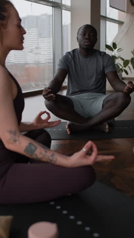 couple meditating in yoga studio