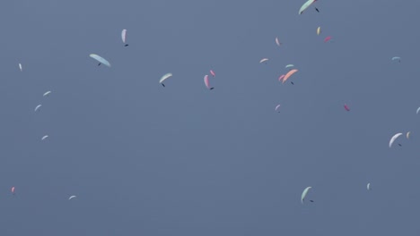 paragliders skydiving in a circle at a competition